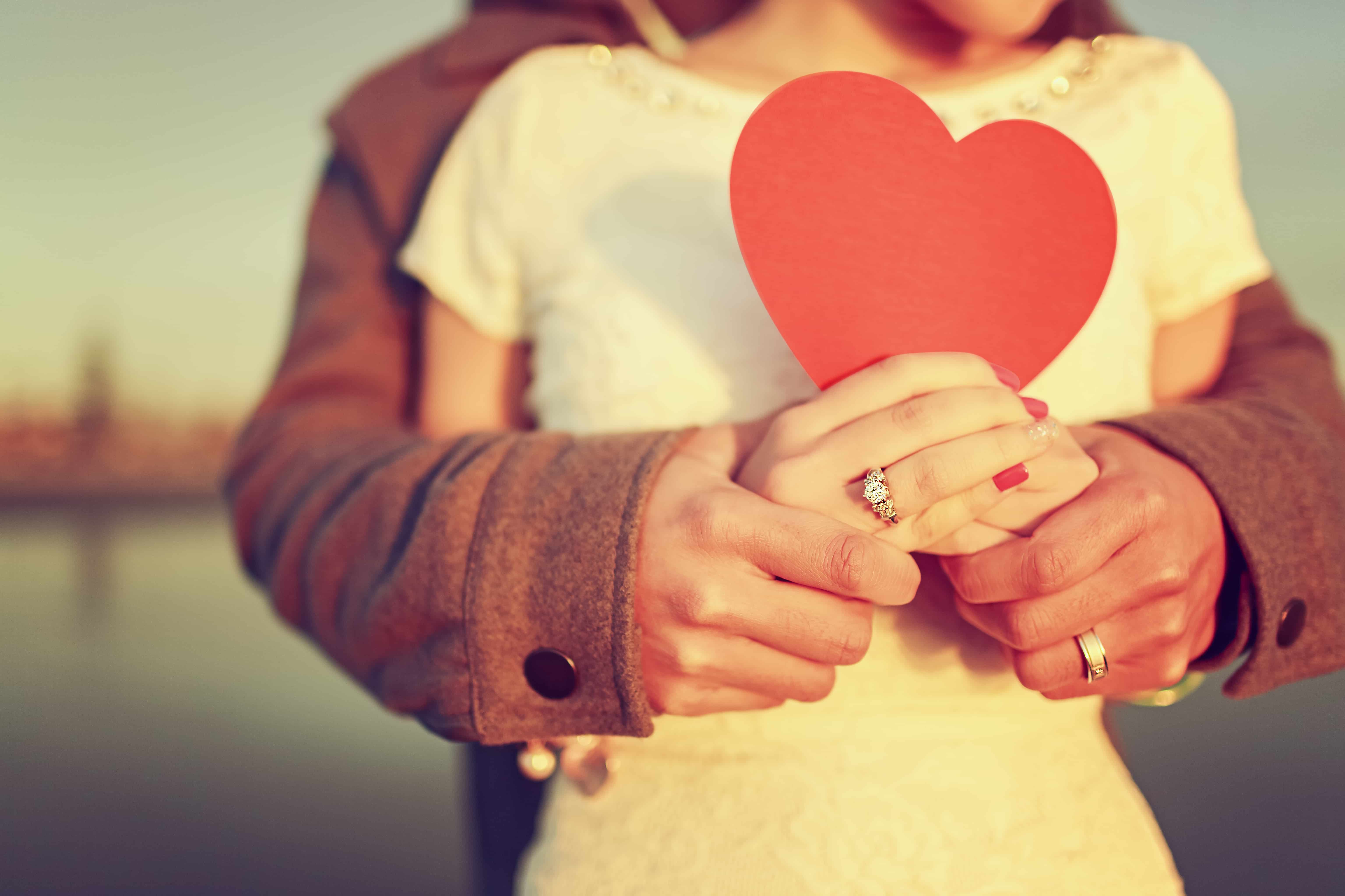 married couple holding a heart